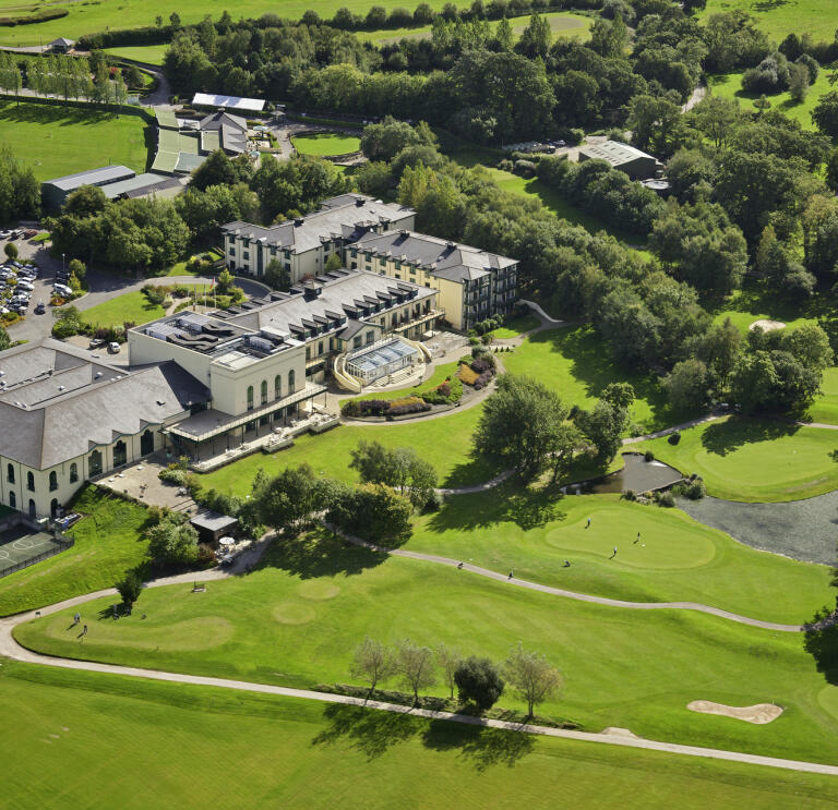 An aerial shot of a grand hotel and its golf couirse.