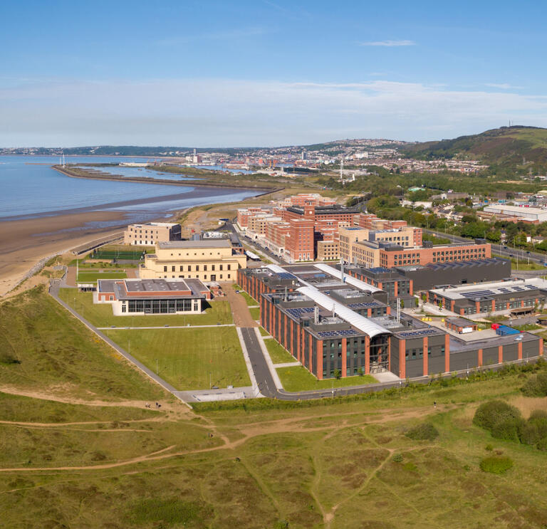 Aerial shot of a university with views across the bay.