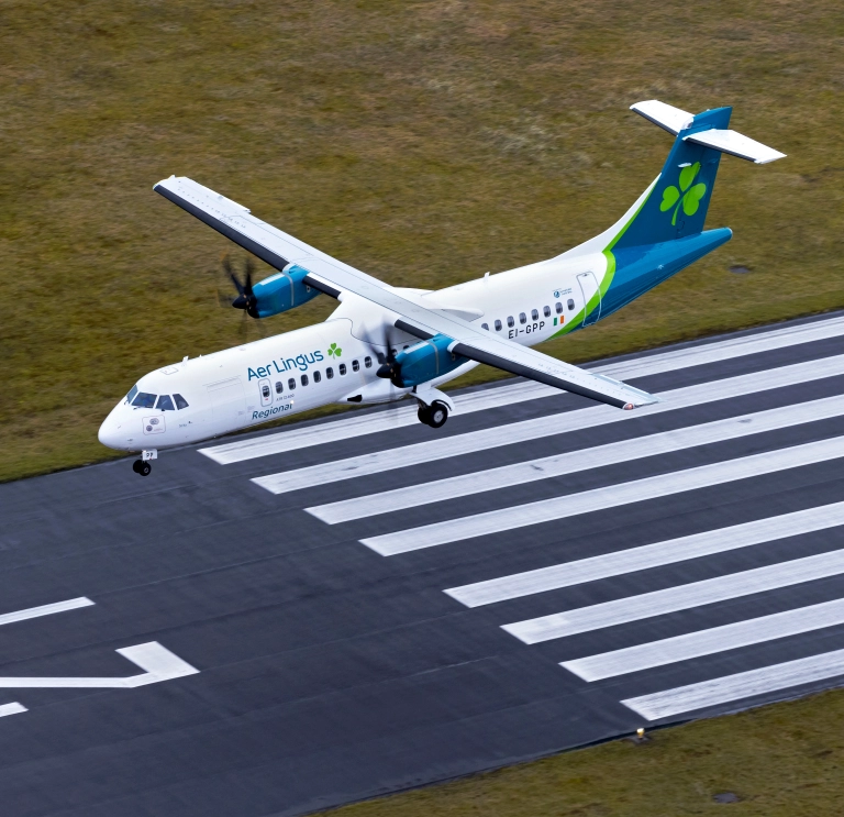 An aeroplane landing at an airport.