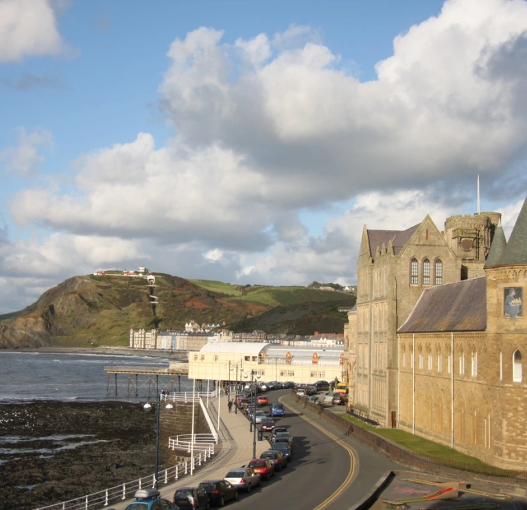 Mountains with sea and building in background 
