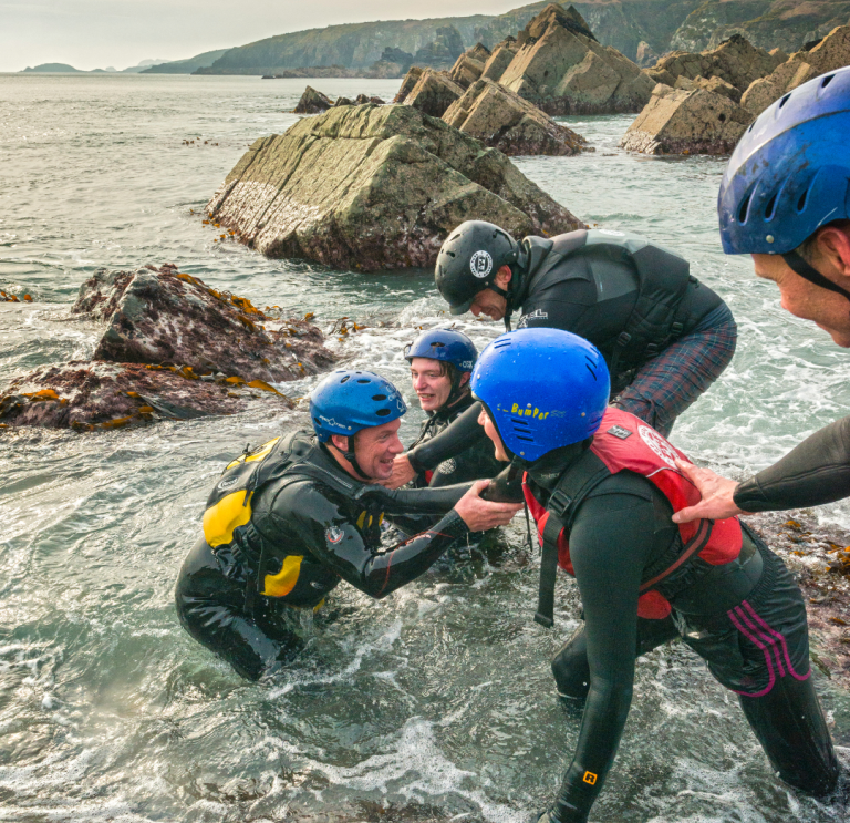 Group of people coasteering near St Davids on the south coast