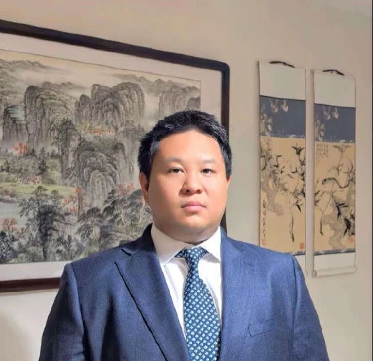 Bio image of Dr. Tiansheng Yang in blue suit and a navy and white polka dot tie