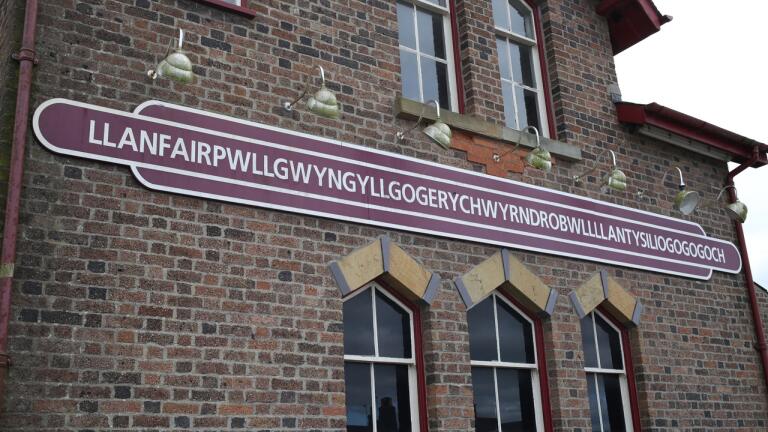A sign on a railway station which shows off the 58 character longest name.