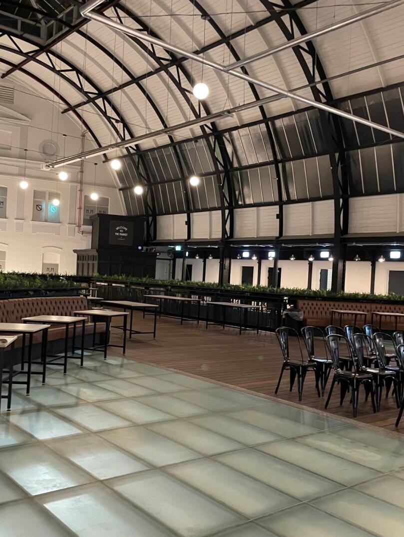 Tables and chairs laid out for meeting space in a Victorian market.