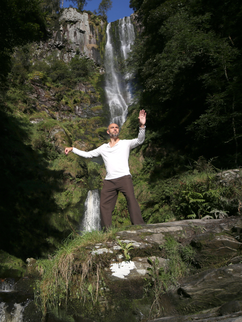 Image of a person in front of a waterfall.