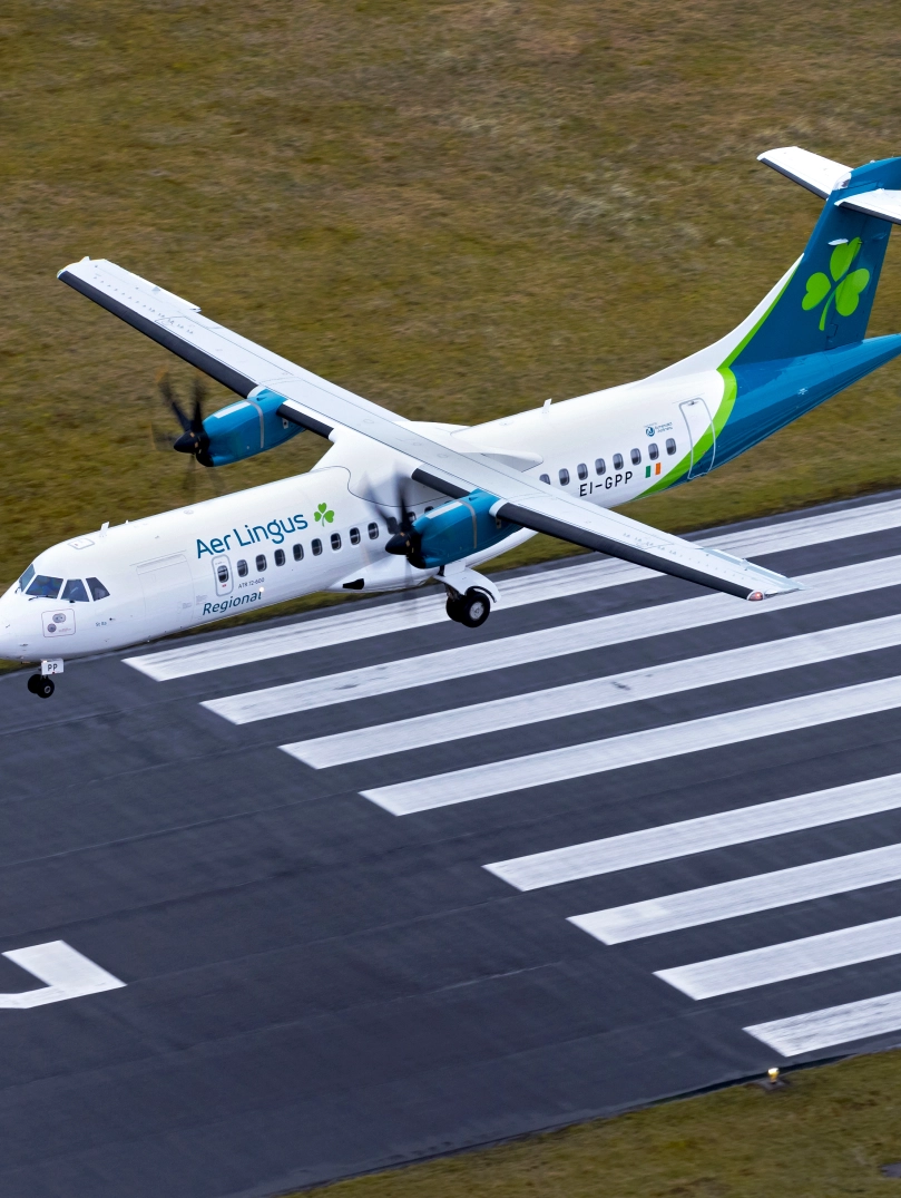 An aeroplane landing at an airport.