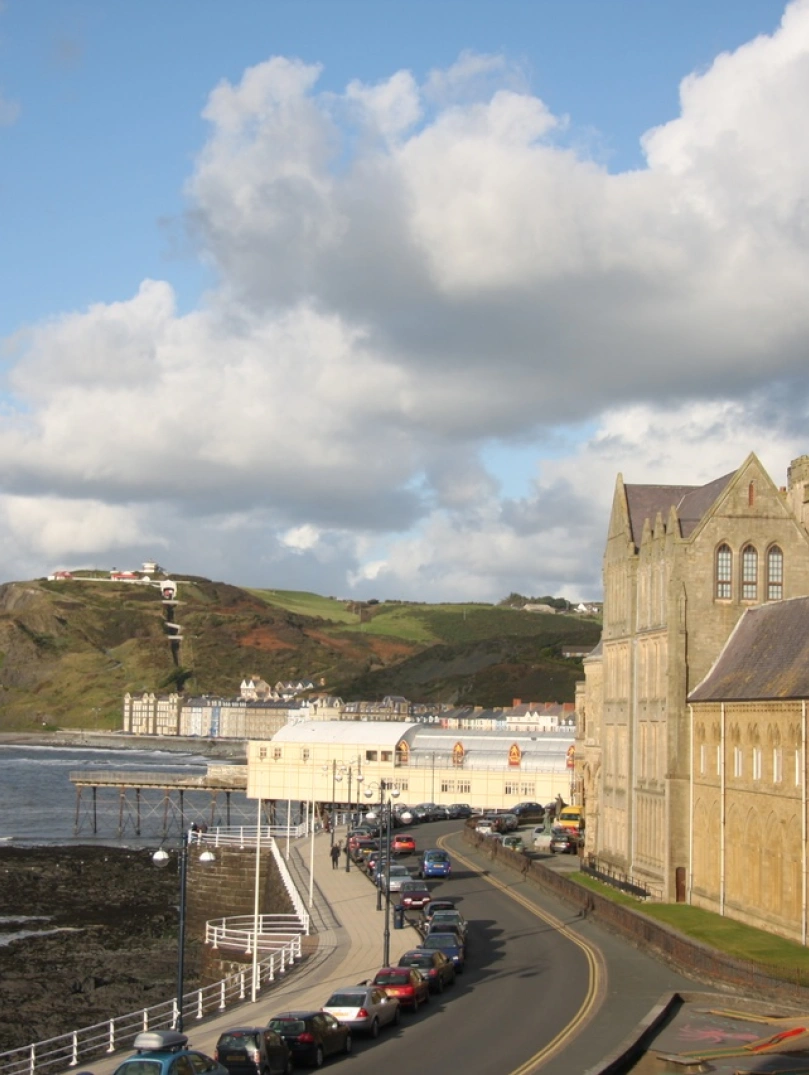 Mountains with sea and building in background