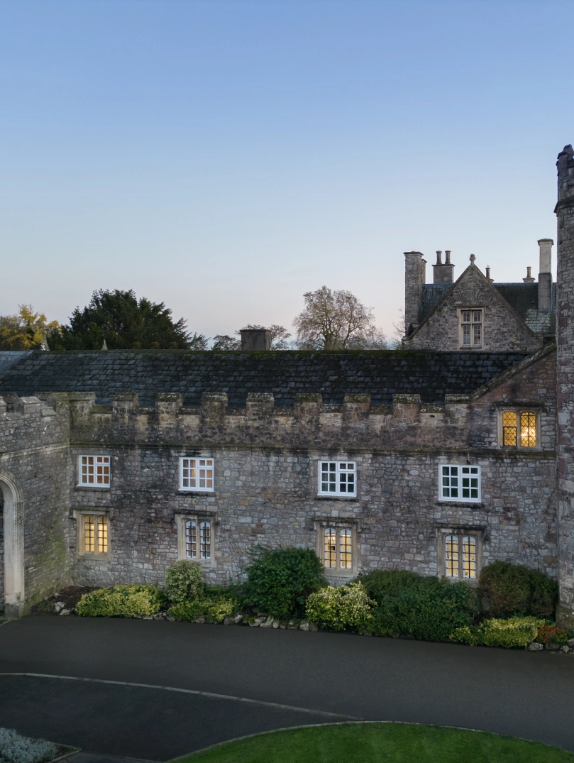 outside of  hotel manicured lawns and blue evening sky behind 