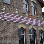 A sign on a railway station which shows off the 58 character longest name.
