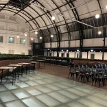 Tables and chairs laid out for meeting space in a Victorian market.