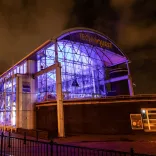 An exterior shot of Techniquest lit up at night.