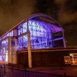 An exterior shot of Techniquest lit up at night.