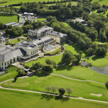 An aerial shot of a grand hotel and its golf couirse.