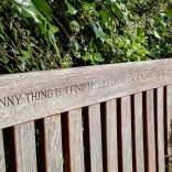Bench etched with the phrase 'The funny thing is, I find myself going back again and again'.
