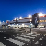 External shot of Cardiff Airport brightly lit at night.