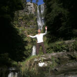 Image of a person in front of a waterfall.