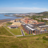 Aerial shot of a university with views across the bay.