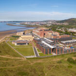 Aerial shot of a university with views across the bay.