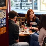 People sitting around a table eating a meal.