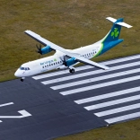 An aeroplane landing at an airport.