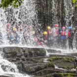 Group of people behind a waterfall 