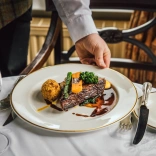 A plate of food being served on a table.