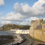 Mountains with sea and building in background 