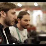 John Jackson  and colleague intently looking at a computer screen 