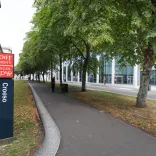 external image of bilingual welcome sign at Cardiff University with trees lining the street  