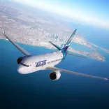 An aircraft in the sky above the sea