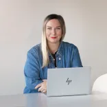 bio image of Sofia Christidi sitting at her laptop working