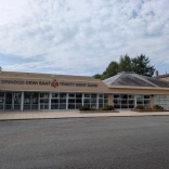 Exterior of the Trinity Saint David building with bilingual Welsh and English signage.