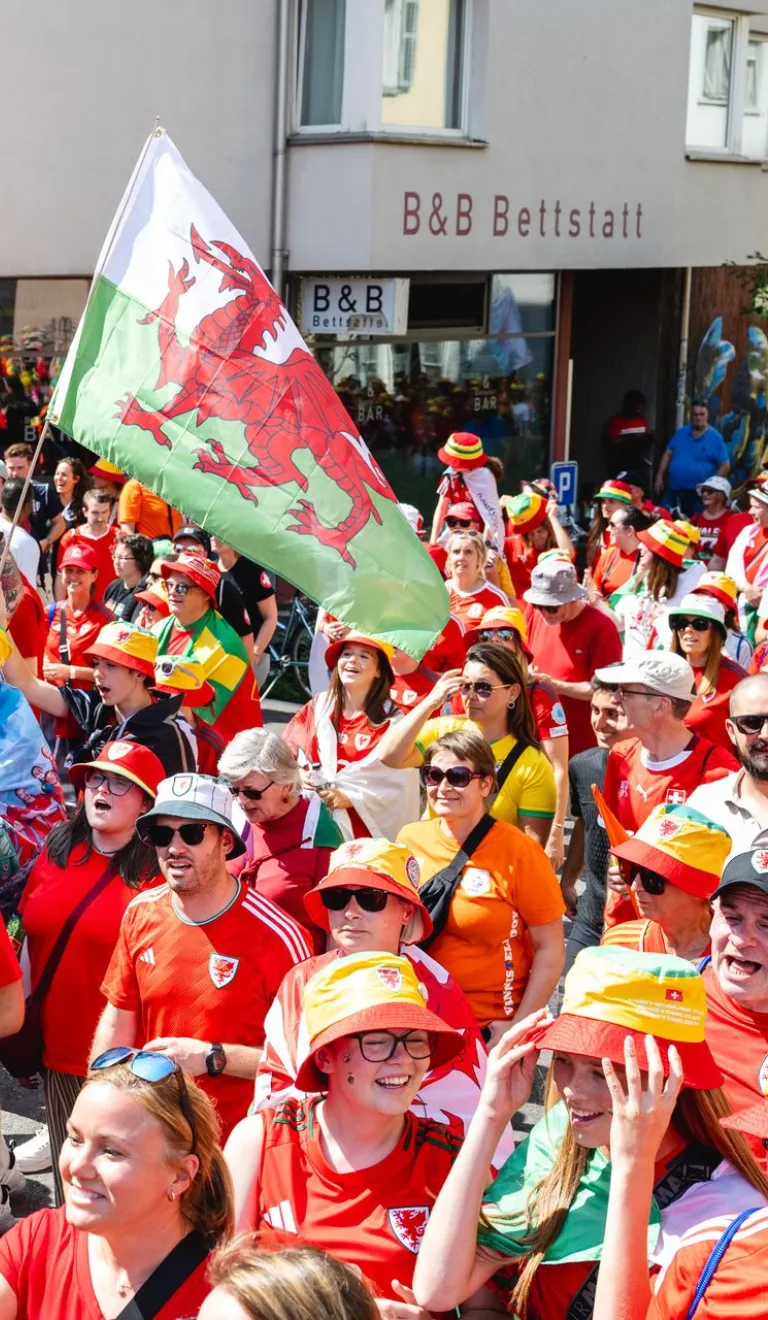 People in Welsh tops and flags at EUROs